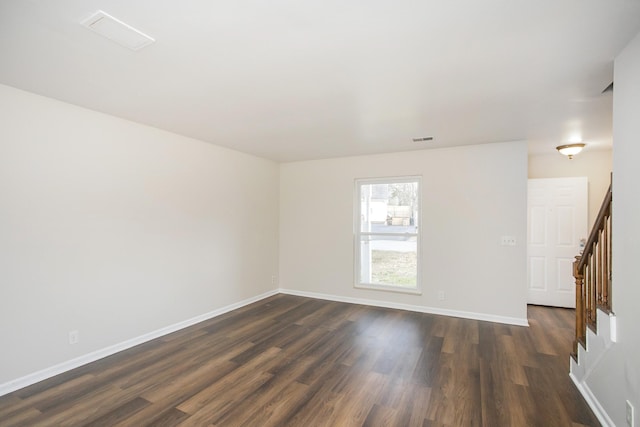 spare room with dark hardwood / wood-style floors