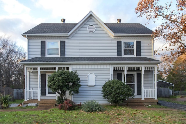 front of property with a front yard and a carport