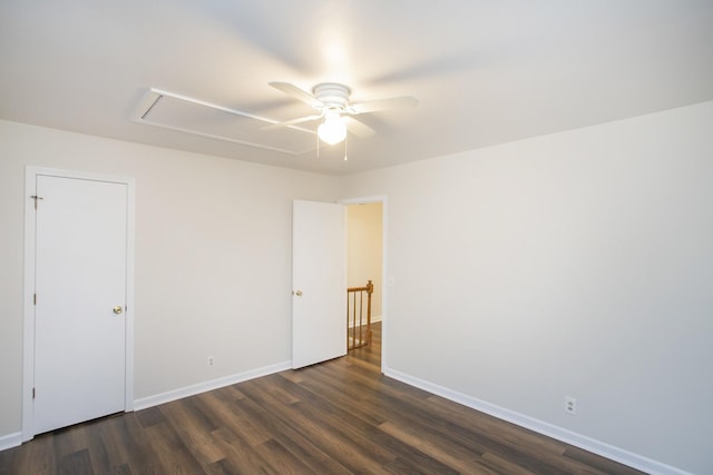 spare room with dark hardwood / wood-style floors and ceiling fan