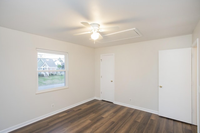 empty room featuring ceiling fan and dark hardwood / wood-style flooring