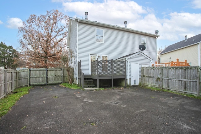 back of house featuring a wooden deck