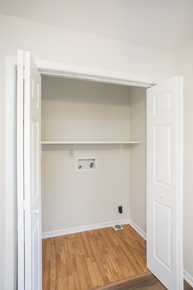 washroom with washer hookup and wood-type flooring