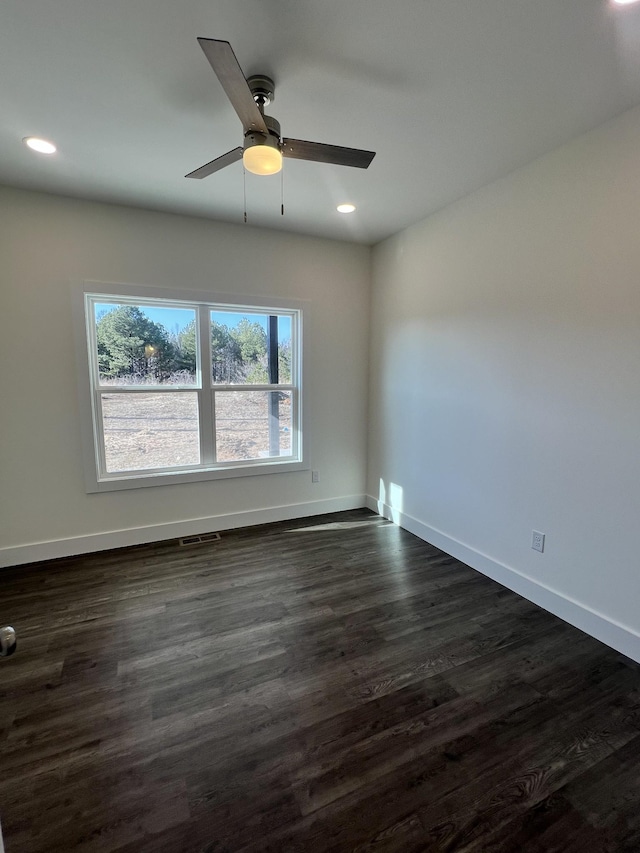 empty room featuring ceiling fan and dark hardwood / wood-style flooring