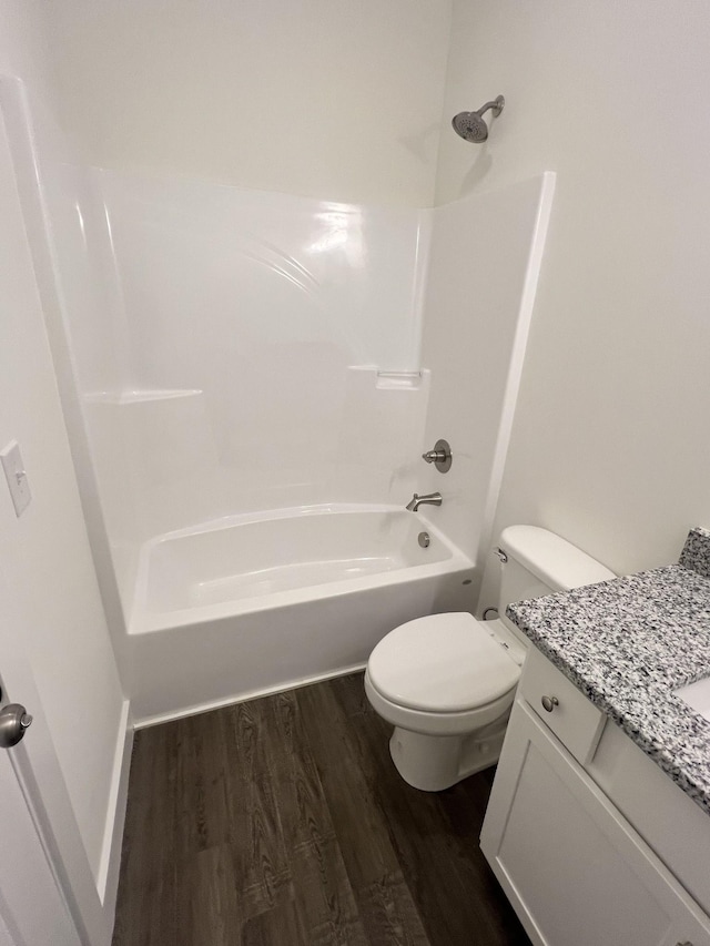 full bathroom featuring hardwood / wood-style flooring, shower / tub combination, vanity, and toilet