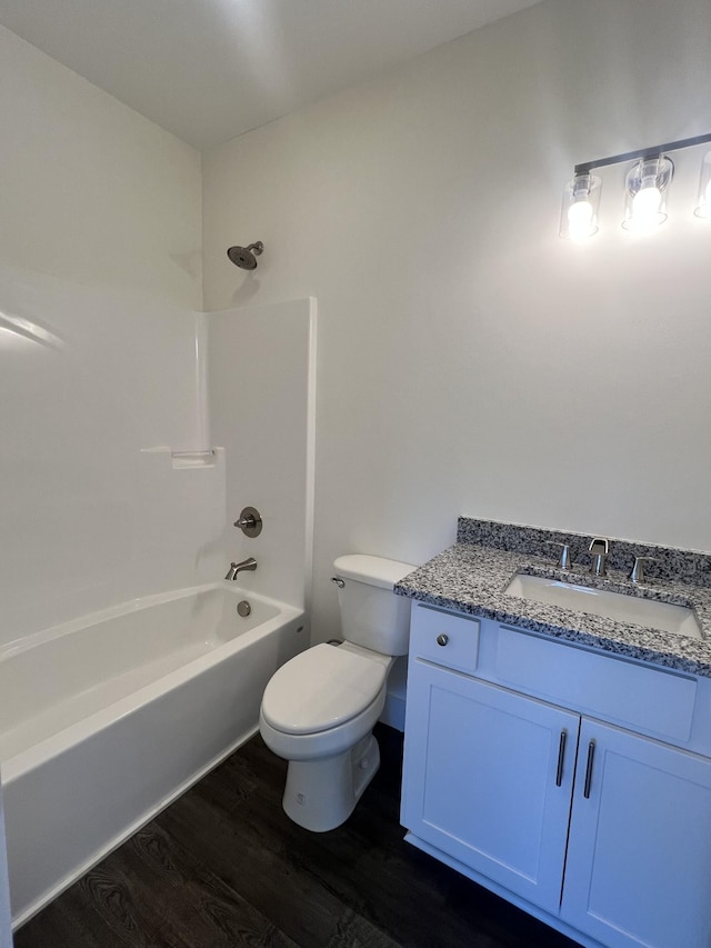 full bathroom featuring vanity, hardwood / wood-style floors,  shower combination, and toilet