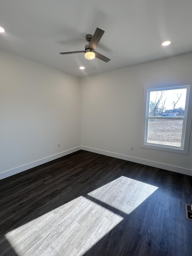 empty room featuring ceiling fan and dark hardwood / wood-style flooring