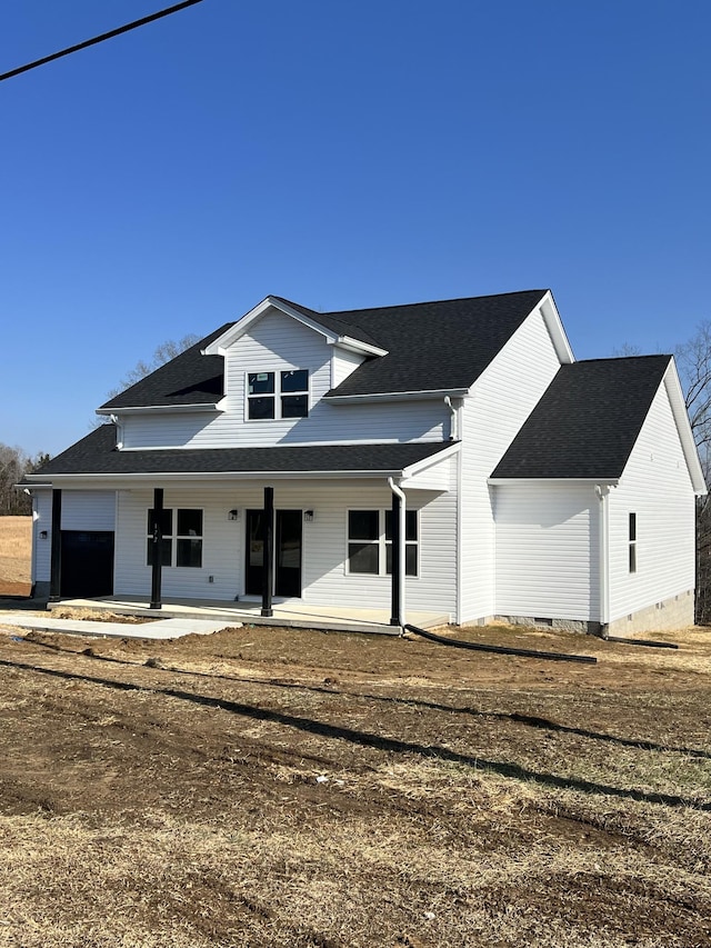 back of property featuring a garage and covered porch