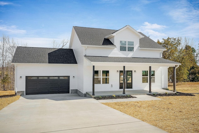 modern farmhouse featuring concrete driveway, an attached garage, covered porch, and a shingled roof