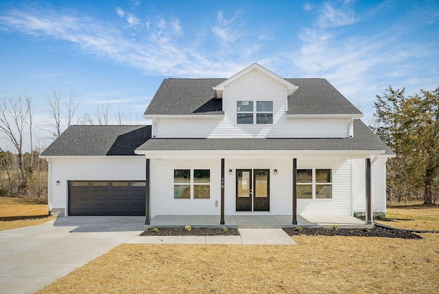 modern inspired farmhouse featuring a porch, an attached garage, roof with shingles, and concrete driveway