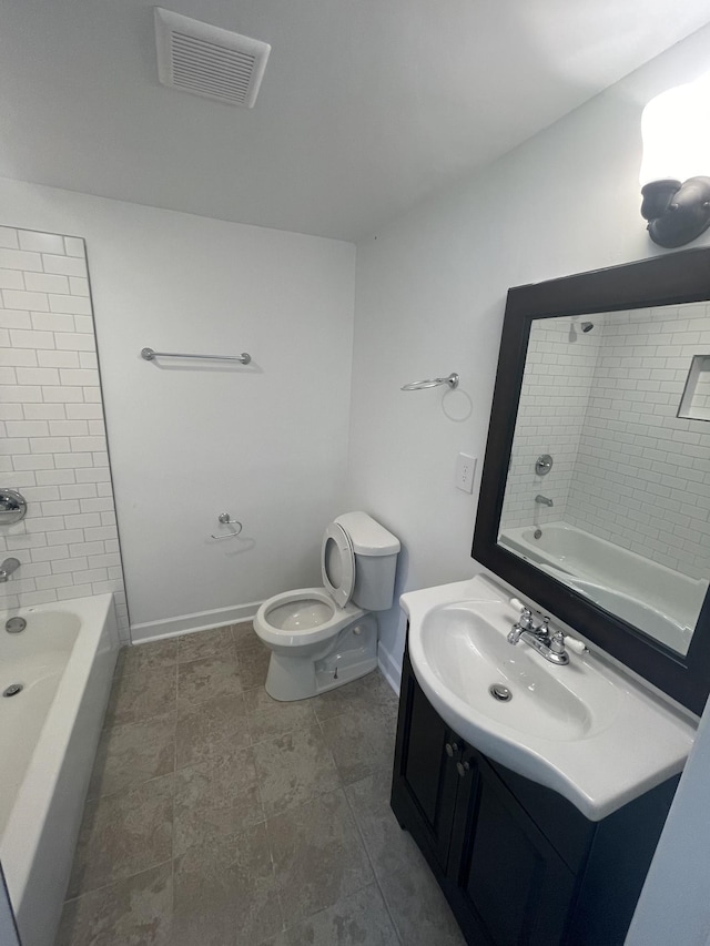 full bathroom with toilet, vanity, and tiled shower / bath