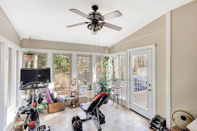 exercise room featuring ceiling fan, a healthy amount of sunlight, and vaulted ceiling