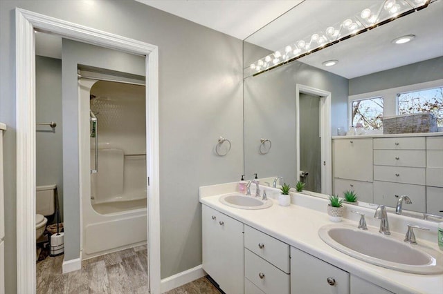 full bathroom with vanity, hardwood / wood-style flooring, toilet, and tub / shower combination