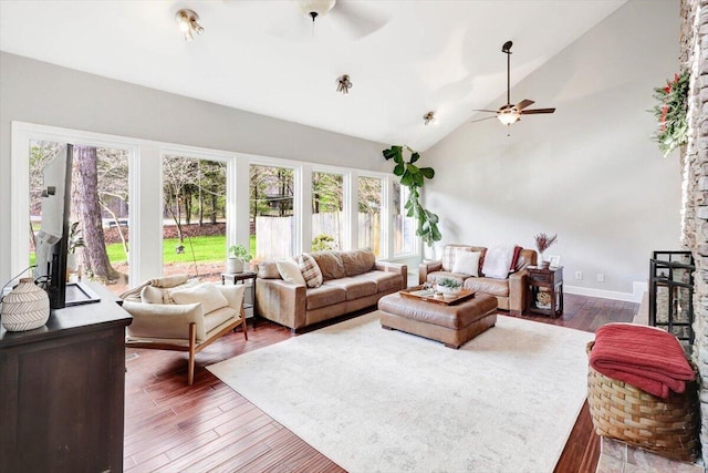 living room with ceiling fan, wood-type flooring, and vaulted ceiling