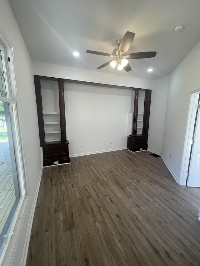 unfurnished bedroom with ceiling fan and dark hardwood / wood-style floors