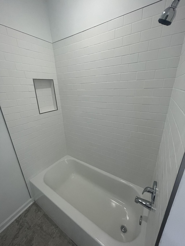 bathroom with tile patterned floors and tiled shower / bath