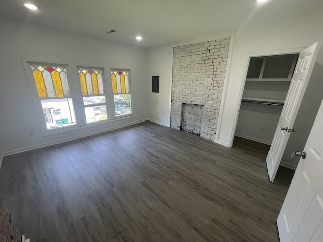 unfurnished living room featuring dark hardwood / wood-style floors and a fireplace