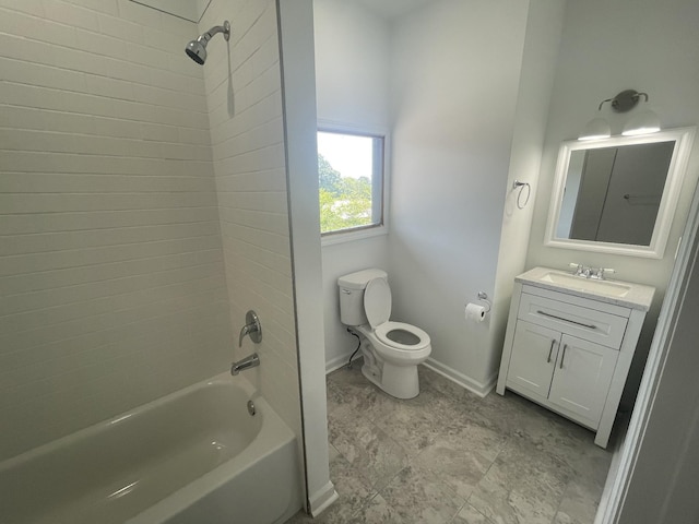 full bathroom featuring vanity, tiled shower / bath combo, and toilet