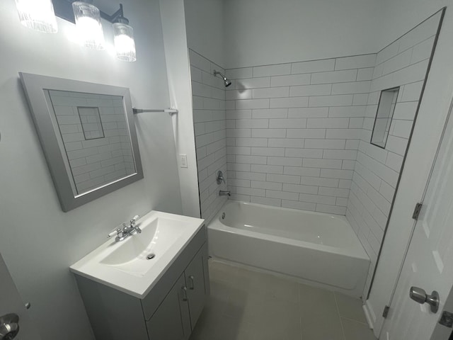 bathroom with tile patterned floors, tiled shower / bath combo, and vanity