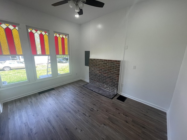 unfurnished living room featuring dark hardwood / wood-style floors and ceiling fan