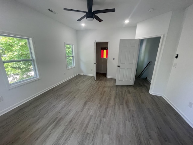 unfurnished bedroom with ceiling fan and dark hardwood / wood-style floors