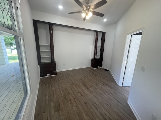 unfurnished bedroom featuring access to exterior, dark hardwood / wood-style floors, and ceiling fan