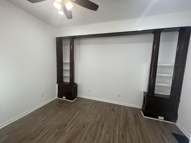 unfurnished room featuring ceiling fan and dark wood-type flooring