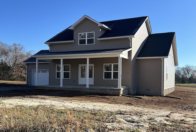 view of front of property featuring a porch and a garage