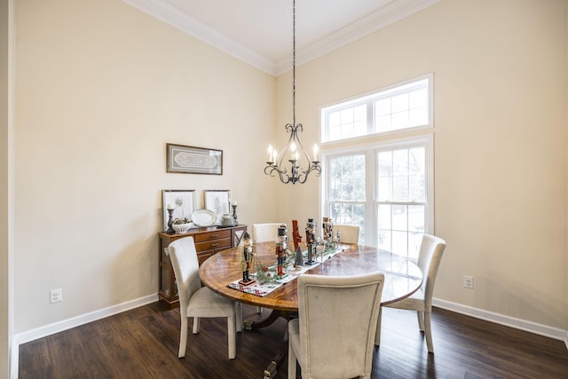 dining space with dark hardwood / wood-style flooring, crown molding, and a chandelier