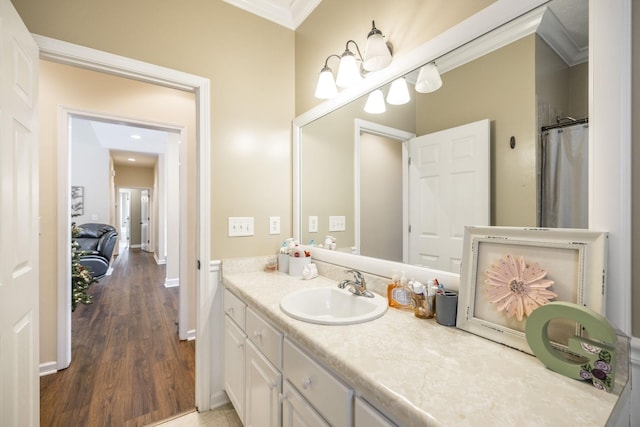 bathroom featuring hardwood / wood-style flooring, vanity, ornamental molding, and a shower with curtain