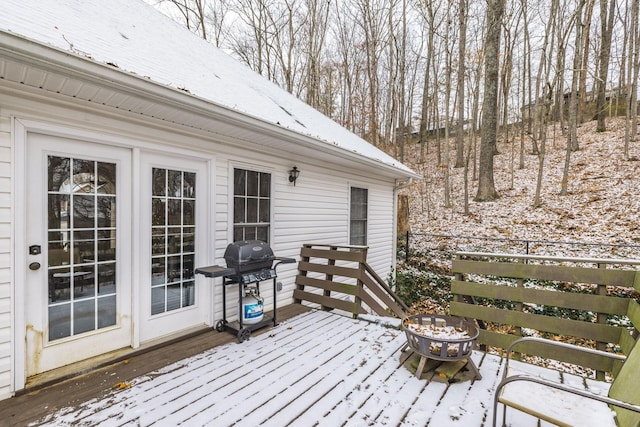 snow covered deck with grilling area