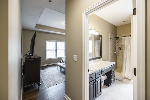 bathroom featuring a shower with shower curtain, vanity, and wood-type flooring