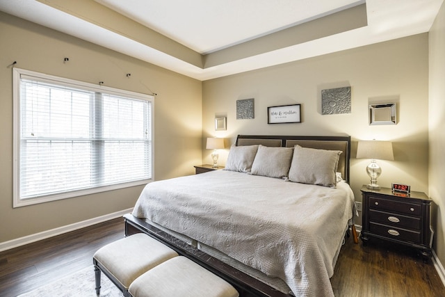 bedroom with dark wood-type flooring and a wall unit AC