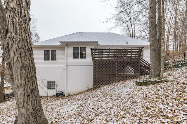 view of snowy exterior with a wooden deck