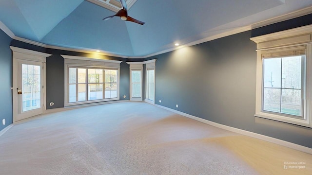 carpeted spare room with ceiling fan, plenty of natural light, high vaulted ceiling, and ornamental molding