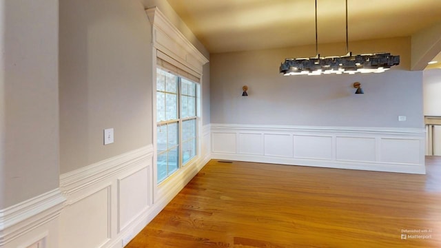 unfurnished dining area featuring wood-type flooring