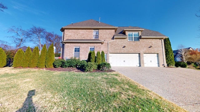 front of property with a front yard and a garage