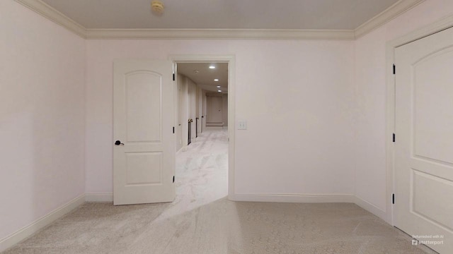 unfurnished room with crown molding and light carpet