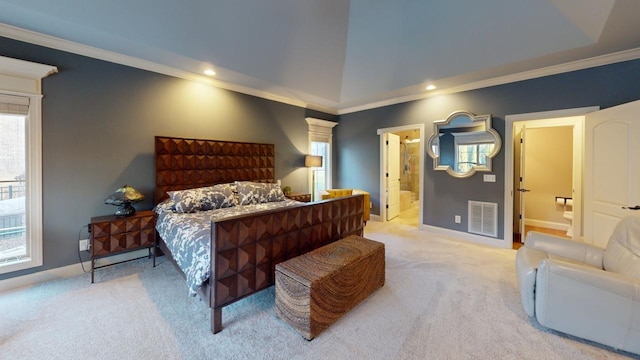 carpeted bedroom with vaulted ceiling, crown molding, and ensuite bath