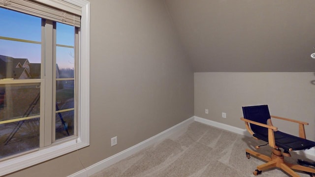 office area with light carpet and vaulted ceiling