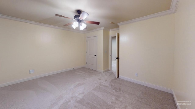 unfurnished room with crown molding, ceiling fan, and light colored carpet