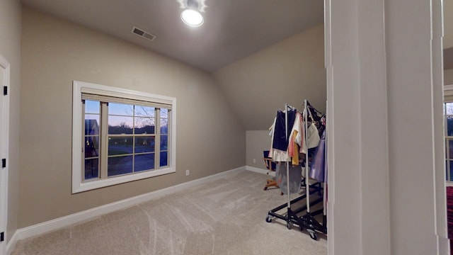 exercise area with light carpet and lofted ceiling