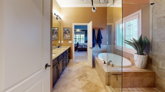 bathroom with vanity, ornamental molding, and tiled tub