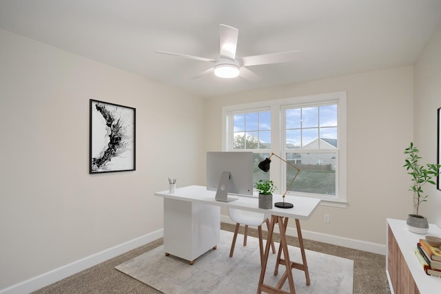 carpeted office space with ceiling fan