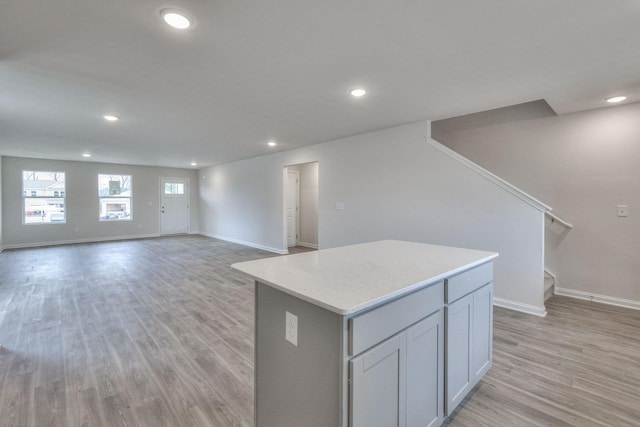 kitchen featuring gray cabinetry, a center island, and light hardwood / wood-style flooring