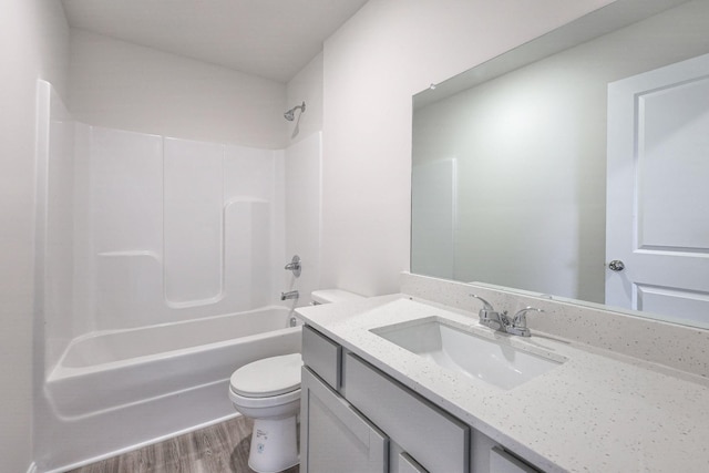 full bathroom featuring bathing tub / shower combination, toilet, vanity, and hardwood / wood-style flooring