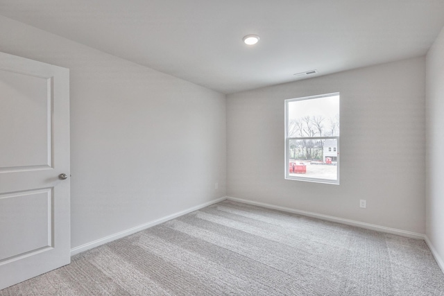 unfurnished room with light colored carpet