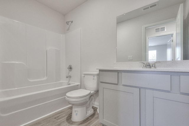 full bathroom featuring hardwood / wood-style flooring, vanity, toilet, and shower / bath combination