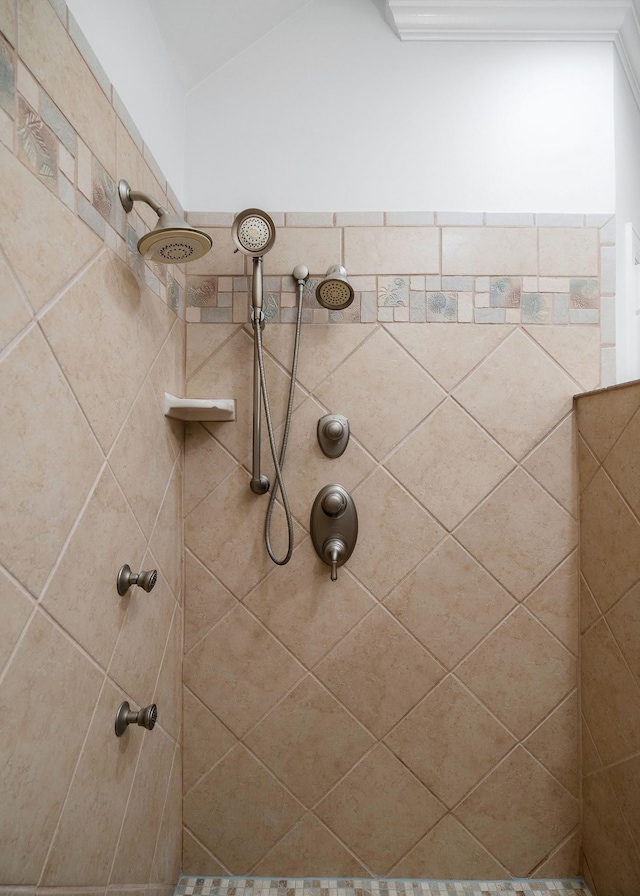 bathroom with a tile shower and vaulted ceiling