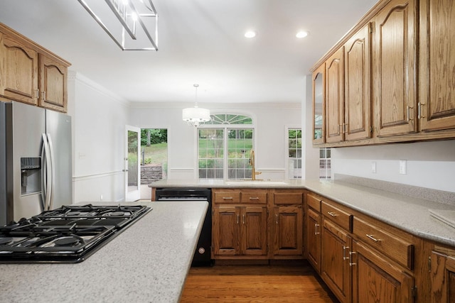 kitchen with stainless steel appliances, crown molding, a healthy amount of sunlight, and sink