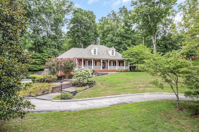 cape cod home with a porch and a front yard